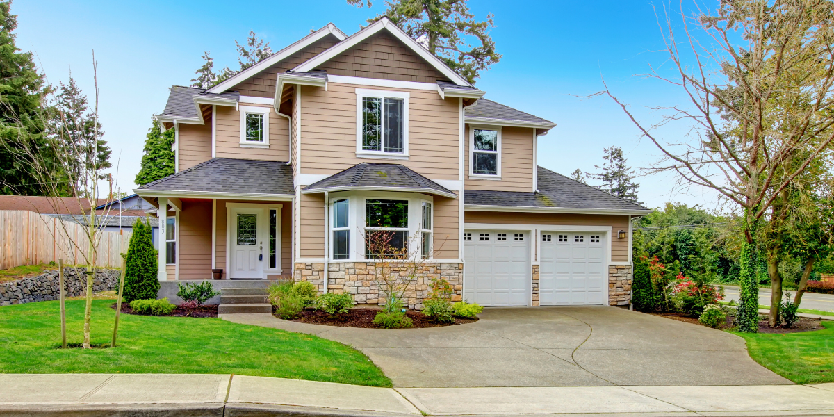 A large house with beige and rock siding