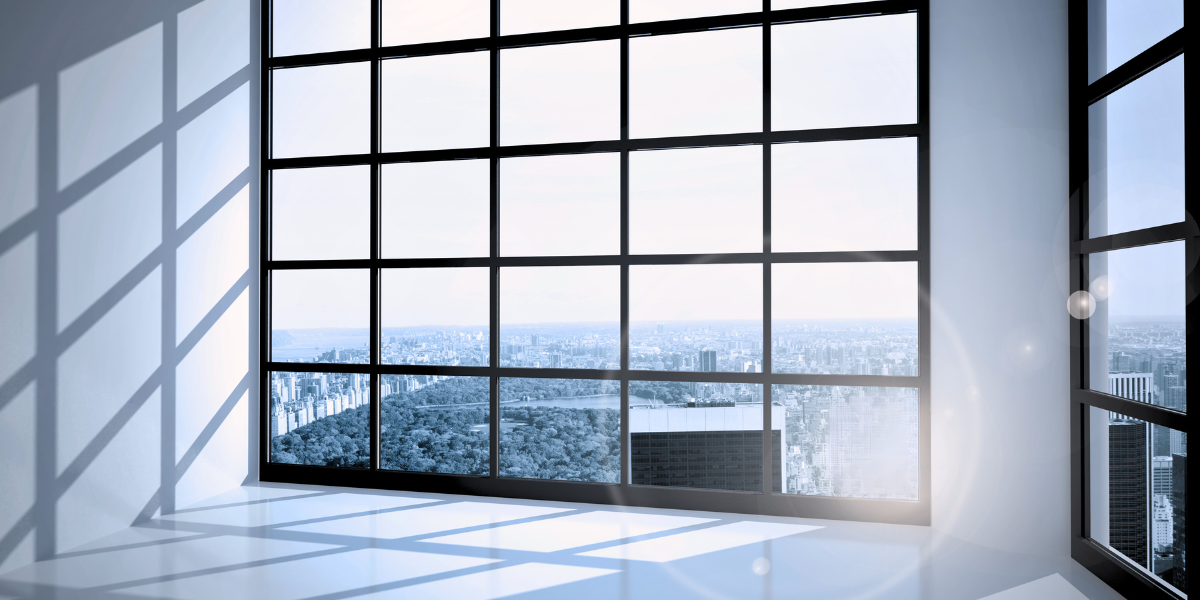 large window with black frames and accents and a skyline view of a city