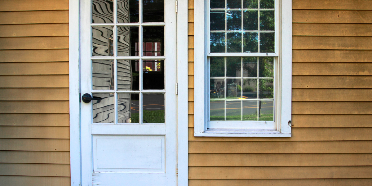 Exterior with older siding and door.