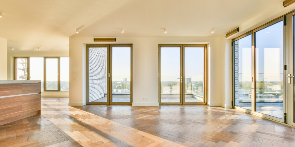 A well-lit living space with large panel windows and natural light.