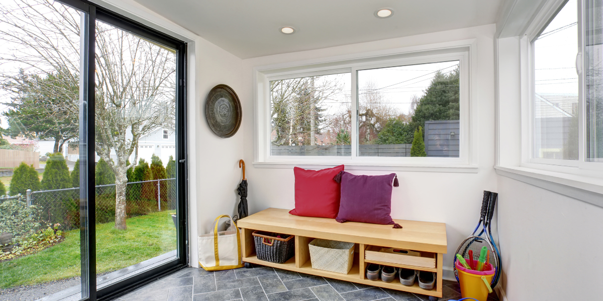 Large glass sliding patio doors opened from backyard to living space in home. 