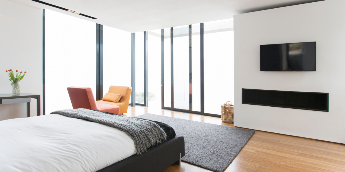Bedroom with large panel glass sliding doors to outside.