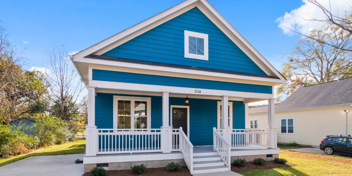 Exterior of a blue house with beautiful siding. 