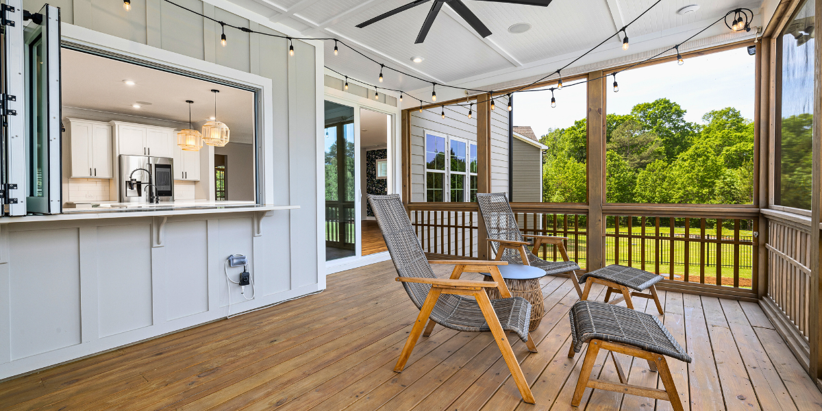 Covered patio deck with sliding windows and doors that flow into the home and outside.