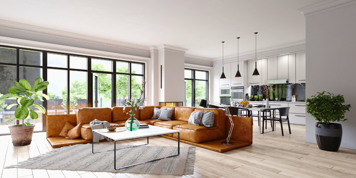An open concept living/dining room and kitchen with lots of floor to ceiling windows. 