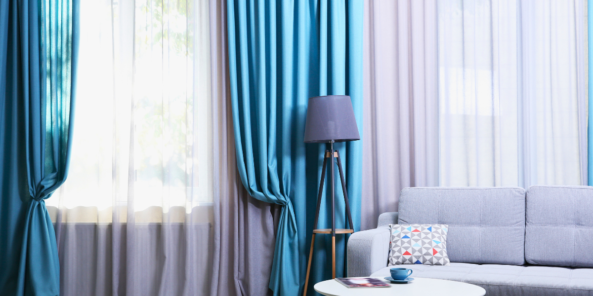 Living room with curtain and drapes. 