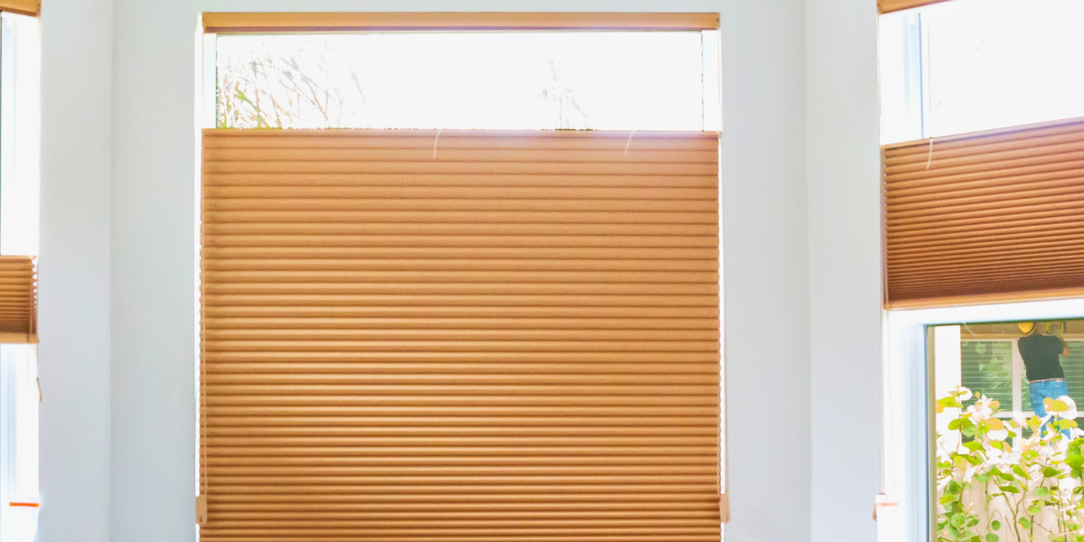 Top-down, bottom-up shades over a window with top portion and bottom portion exposed.