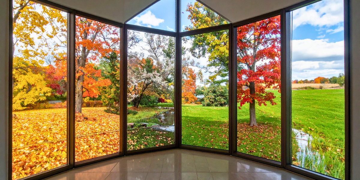 Floor-to-ceiling windows showing the changing seasons.