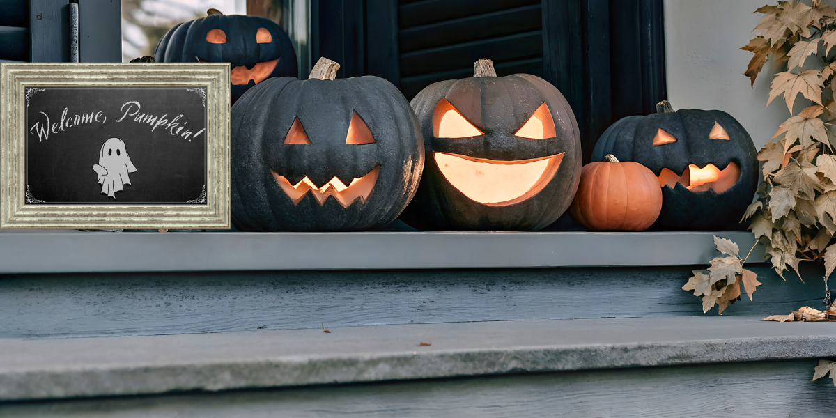 Pumpkins on a porch next to a chalkboard sign that reads "Welcome, Pumpkin"